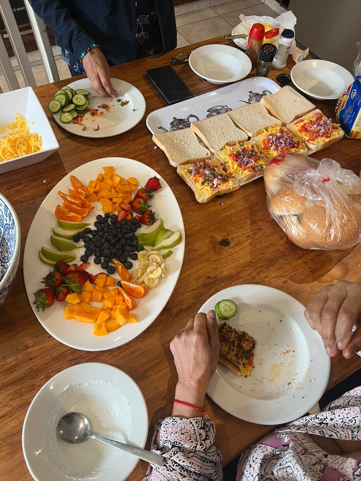 Fruit, flowers and shared dishes on the table